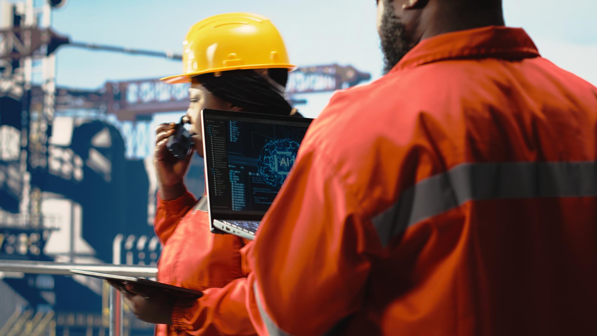 Offshore platform crew using artificial intelligence program on laptop to optimize drilling