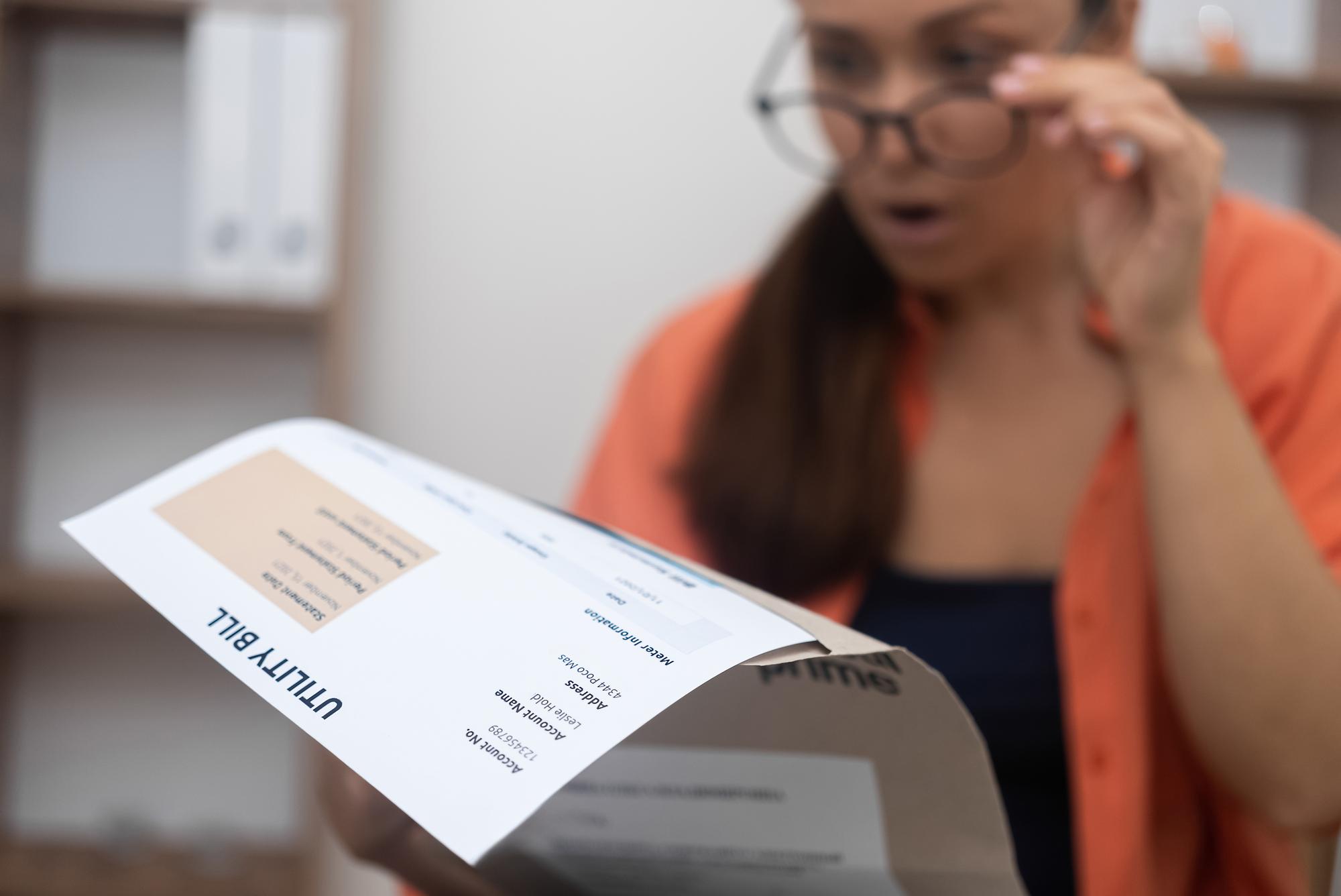 Uma senhora preocupada e preocupada examina o pagamento de uma hipoteca de uma conta de serviços públicos e o aumento da dívida